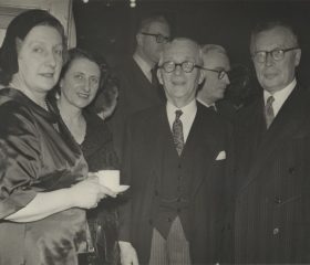Kārlis Zariņš ar kundzi Henrieti (pirmā no kreisās) 18. novembra pieņemšanā ar igauņu sūtni Augustu Tormu (pirmais no labās) un viņa kundzi (otrā no kreisās). Avots: LNA_LVA, F2263_1_248, 22. lp.